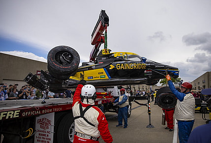 May 27, 2022; Indianapolis, Indiana, USA; The crashed car of IndyCar Series driver Colton Herta is unloaded by a tow truck in the garage area after crashing during Carb Day practice at Indianapolis Motor Speedway. Mandatory Credit: Mark J. Rebilas-USA TODAY Sports