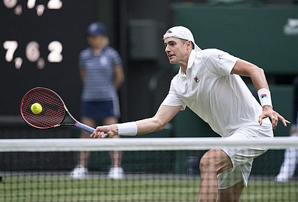 Jun 29, 2022; London, United Kingdom; John Isner (USA) returns a shot during his second round match against Andy Murray (GBR) on day three at All England Lawn Tennis and Croquet Club. Mandatory Credit: Susan Mullane-USA TODAY Sports