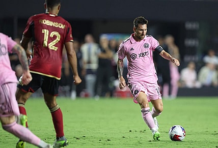 Jul 25, 2023; Fort Lauderdale, FL, USA; Inter Miami CF forward Lionel Messi (10) dribbles against Atlanta United defender Ronald Hernandez (2) during the second half at DRV PNK Stadium. Mandatory Credit: Nathan Ray Seebeck-USA TODAY Sports