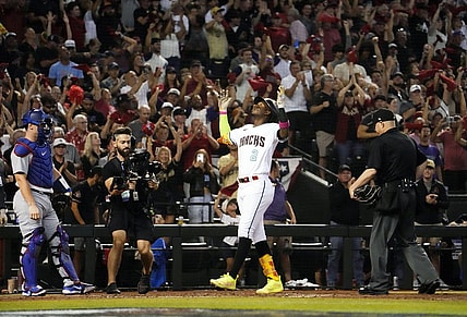 Oct 11, 2023; Phoenix, AZ, USA; Arizona Diamondbacks Geraldo Perdomo (2) reacts after hitting a home run off Los Angeles Dodgers starting pitcher Lance Lynn (35) in the third inning during Game 3 of the NLDS at Chase Field. Mandatory Credit: Rob Schumacher-Arizona Republic