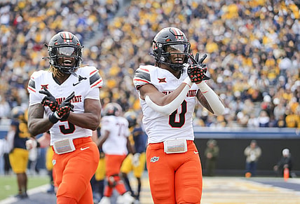Oct 21, 2023; Morgantown, West Virginia, USA; Oklahoma State Cowboys running back Ollie Gordon II (0) celebrates after running for a touchdown during the first quarter against the West Virginia Mountaineers at Mountaineer Field at Milan Puskar Stadium. Mandatory Credit: Ben Queen-USA TODAY Sports