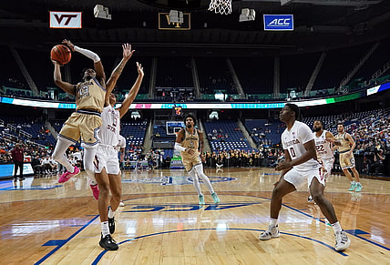 Mar 7, 2023; Greensboro, NC, USA; Georgia Tech Yellow Jackets guard Miles Kelly (13) goes up for a shot against Florida State Seminoles forward Cam Corhen (3) during the second half of the first round of the ACC tournament at Greensboro Coliseum. Mandatory Credit: John David Mercer-USA TODAY Sports