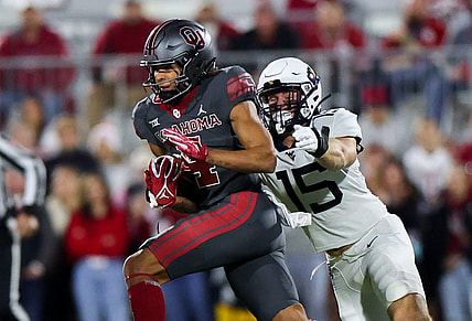 Nov 11, 2023; Norman, Oklahoma, USA;  Oklahoma Sooners wide receiver Nic Anderson (4) runs with the ball as West Virginia Mountaineers linebacker Ben Cutter (15) defends during the first quarter at Gaylord Family-Oklahoma Memorial Stadium. Mandatory Credit: Kevin Jairaj-USA TODAY Sports