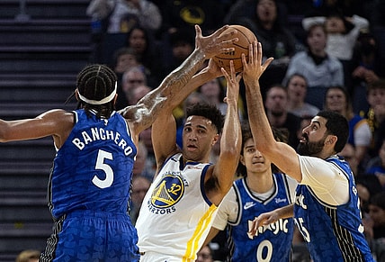 Jan 2, 2024; San Francisco, California, USA; Golden State Warriors forward Trayce Jackson-Davis (32) looks to pass away from defensive pressure from Orlando Magic players during the second quarter at Chase Center. Mandatory Credit: D. Ross Cameron-USA TODAY Sports
