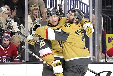 Vegas Golden Knights defenseman Noah Hanifin (15) celebrates with Vegas Golden Knights defenseman Alex Pietrangelo (7) after scoring a goal against the Montreal Canadiens during the first period of an NHL hockey game Tuesday, Dec. 31, 2024, in Las Vegas. (Steve Marcus/Las Vegas Sun via AP)