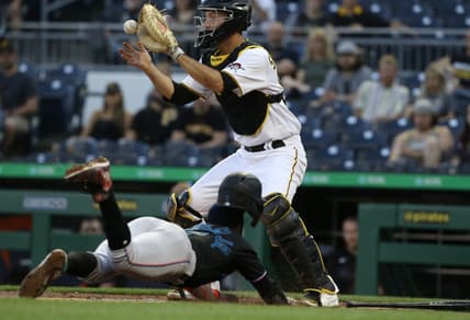 Jun 4, 2021; Pittsburgh, Pennsylvania, USA;  Pittsburgh Pirates catcher Jacob Stallings (58) takes a throw to force Miami Marlins shortstop Jazz Chisholm Jr. (2) out at home during the second inning at PNC Park. Mandatory Credit: Charles LeClaire-USA TODAY Sports