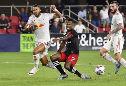 Jul 25, 2021; Washington, DC, Washington, DC, USA; New York Red Bulls defender Amro Tarek (3) blocks the shot by D.C. United forward Ola Kamara (9) during the first half at Audi Field. Mandatory Credit: Brad Mills-USA TODAY Sports