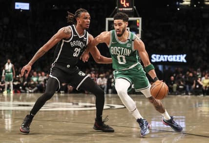 Apr 23, 2022; Brooklyn, New York, USA;  Boston Celtics forward Jayson Tatum (0) drives past Brooklyn Nets forward Nic Claxton (33) in the first quarter at Barclays Center. Mandatory Credit: Wendell Cruz-USA TODAY Sports