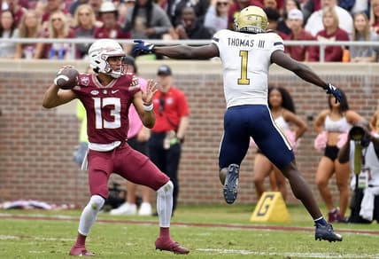 Oct 29, 2022; Tallahassee, Florida, USA; Florida State Seminoles quarterback Jordan Travis (13) is pressured by Georgia Tech Yellow Jackets linebacker Charlie Thomas (1)  during the first half at Doak S. Campbell Stadium. Mandatory Credit: Melina Myers-USA TODAY Sports