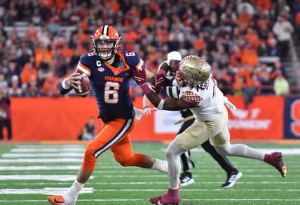 Nov 12, 2022; Syracuse, New York, USA;  Syracuse Orange quarterback Garrett Shrader (6) tries to shake a tackle by Florida State Seminoles linebacker Kalen DeLoach (4) in the second quarter at JMA Wireless Dome. Mandatory Credit: Mark Konezny-USA TODAY Sports
