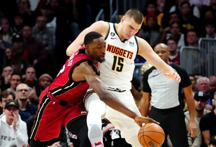 Dec 30, 2022; Denver, Colorado, USA; Miami Heat center Bam Adebayo (13) steals the ball away from Denver Nuggets center Nikola Jokic (15) in the second half at Ball Arena. Mandatory Credit: Ron Chenoy-USA TODAY Sports