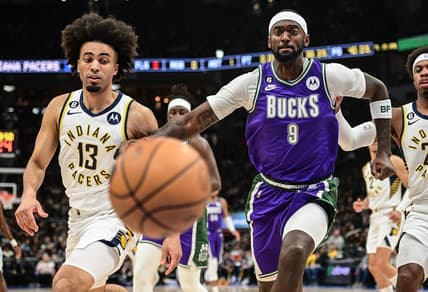Mar 16, 2023; Milwaukee, Wisconsin, USA; Milwaukee Bucks forward Bobby Portis (9) and Indiana Pacers forward Jordan Nwora (13) chase a loose ball in the first quarter at Fiserv Forum. Mandatory Credit: Benny Sieu-USA TODAY Sports