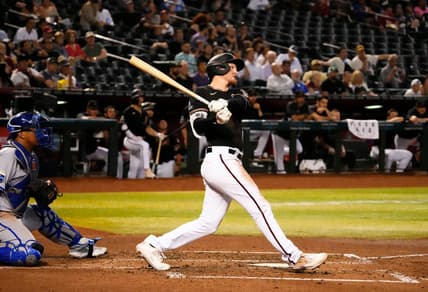 Apr 24, 2023; Phoenix, AZ, USA;  Arizona Diamondbacks Pavin Smith (26) hits an RBI-single against the Kansas City Royals in the third inning at Chase Field. Mandatory Credit: Rob Schumacher-Arizona Republic

Mlb Royals At D Backs