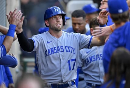 Apr 22, 2023; Anaheim, California, USA;  Kansas City Royals third baseman Hunter Dozier (17) is greeted in the dugout after scoring on a single by shortstop Bobby Witt Jr. (7) in the third inning against the Los Angeles Angels at Angel Stadium. Mandatory Credit: Jayne Kamin-Oncea-USA TODAY Sports