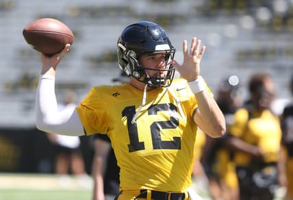 Iowa quarterback Cade McNamara (12) warms up before practice during Kids' Day at Kinnick Stadium on Saturday, Aug. 12, 2023, in Iowa City, Iowa