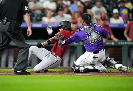 Aug 15, 2023; Denver, Colorado, USA; Colorado Rockies catcher Elias Diaz (35) tags out Arizona Diamondbacks second baseman Ketel Marte (4) in the seventh inning at Coors Field. Mandatory Credit: Ron Chenoy-USA TODAY Sports