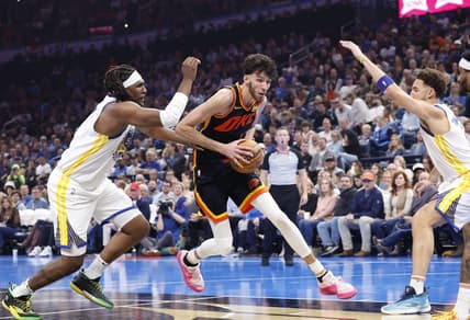 Nov 3, 2023; Oklahoma City, Oklahoma, USA; Oklahoma City Thunder forward Chet Holmgren (7) drives between Golden State Warriors forward Kevon Looney (5) and guard Klay Thompson (11) during the second quarter at Paycom Center. Mandatory Credit: Alonzo Adams-USA TODAY Sports