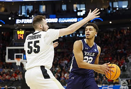 Mar 18, 2022; Milwaukee, WI, USA; Yale Bulldogs forward Matt Knowling (22) controls the ball as Purdue Boilermakers guard Sasha Stefanovic (55) defends during the first half in the first round of the 2022 NCAA Tournament at Fiserv Forum. Mandatory Credit: Jeff Hanisch-USA TODAY Sports