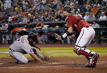 Jun 26, 2022; Phoenix, Ariz., U.S.; Detroit Tigers second baseman Jonathan Schoop (7) scores ahead of the tag by Arizona Diamondbacks catcher Carson Kelly (18) during the third inning at Chase Field. Mandatory Credit: Michael Chow-Arizona Republic

Mlb Tigers At Dbacks