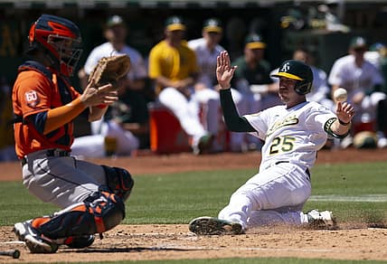 Jul 27, 2022; Oakland, California, USA; Oakland Athletics left fielder Stephen Piscotty (25) slides safely home ahead of the relay to Houston Astros catcher Korey Lee (38) on an RBI single by Skye Bolt during the seventh inning at RingCentral Coliseum. Mandatory Credit: D. Ross Cameron-USA TODAY Sports
