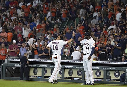 Aug 3, 2022; Houston, Texas, USA; Houston Astros center fielder Mauricio Dubon (14) and designated hitter Yordan Alvarez (44) celebrate their win against the Boston Red Sox in the ninth at Minute Maid Park. Mandatory Credit: Thomas Shea-USA TODAY Sports