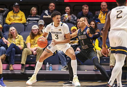 Nov 15, 2022; Morgantown, West Virginia, USA; West Virginia Mountaineers forward Tre Mitchell (3) backs down Morehead State Eagles guard Tucson Redding (1) during the first half at WVU Coliseum. Mandatory Credit: Ben Queen-USA TODAY Sports