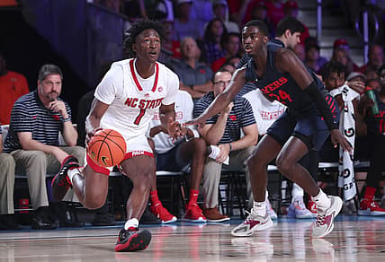 Nov 24, 2022; Paradise Island, BAHAMAS; North Carolina State Wolfpack guard Jarkel Joiner (1) looks to shoot as Dayton Flyers guard Kobe Elvis (24) defends during the first half at Imperial Arena. Mandatory Credit: Kevin Jairaj-USA TODAY Sports