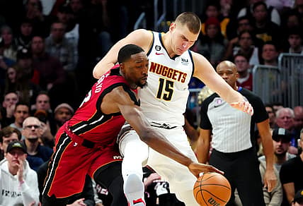 Dec 30, 2022; Denver, Colorado, USA; Miami Heat center Bam Adebayo (13) steals the ball away from Denver Nuggets center Nikola Jokic (15) in the second half at Ball Arena. Mandatory Credit: Ron Chenoy-USA TODAY Sports