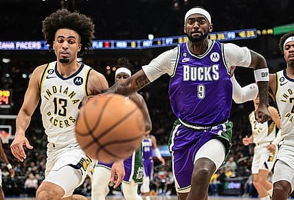 Mar 16, 2023; Milwaukee, Wisconsin, USA; Milwaukee Bucks forward Bobby Portis (9) and Indiana Pacers forward Jordan Nwora (13) chase a loose ball in the first quarter at Fiserv Forum. Mandatory Credit: Benny Sieu-USA TODAY Sports
