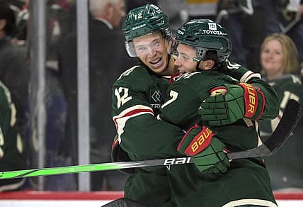 Oct 12, 2023; Saint Paul, Minnesota, USA; Minnesota Wild defense Brock Faber (7) celebrates his goal against the Florida Panthers with forward Matt Boldy (12) during the first period at Xcel Energy Center. Mandatory Credit: Nick Wosika-USA TODAY Sports