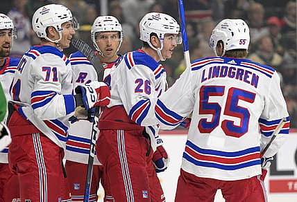 Nov 4, 2023; Saint Paul, Minnesota, USA; New York Rangers forward Jimmy Vesey (26) celebrates his goal against the Minnesota Wild with forward Tyler Pitlick (71) and defenseman Ryan Lindgren (55) during the first period at Xcel Energy Center. Mandatory Credit: Nick Wosika-USA TODAY Sports