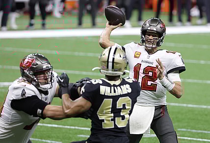 Jan 17, 2021; New Orleans, LA, USA; Tampa Bay Buccaneers quarterback Tom Brady (12) throws a touchdown pass to wide receiver Mike Evans (not pictured) against the New Orleans Saints during the second quarter in a NFC Divisional Round playoff game at Mercedes-Benz Superdome. Mandatory Credit: Derick E. Hingle-USA TODAY Sports