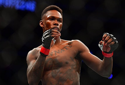 Mar 7, 2020; Las Vegas, Nevada, USA; Israel Adesanya (red gloves) before the match against Yoel Romero (blue gloves) during UFC 248 at T-Mobile Arena. Mandatory Credit: Stephen R. Sylvanie-USA TODAY Sports