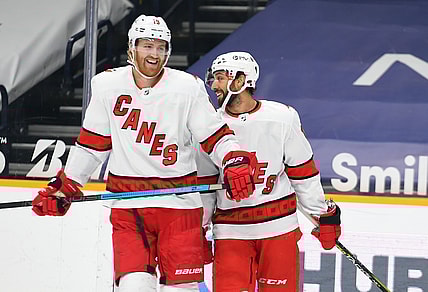 Mar 2, 2021; Nashville, Tennessee, USA; Carolina Hurricanes defenseman Dougie Hamilton (19) and Carolina Hurricanes center Vincent Trocheck (16) react after a goal during the first period against the Nashville Predators at Bridgestone Arena. Mandatory Credit: Christopher Hanewinckel-USA TODAY Sports