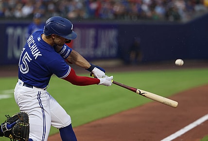 Jul 16, 2021; Buffalo, New York, USA;  Toronto Blue Jays right fielder Randal Grichuk (15) hits a home run during the third inning against the Texas Rangers at Sahlen Field. Mandatory Credit: Timothy T. Ludwig-USA TODAY Sports