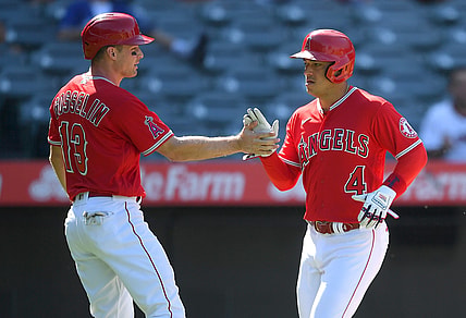 Aug 10, 2021; Anaheim, California, USA;  Los Angeles Angels second baseman Phil Gosselin (13) and shortstop Jose Iglesias (4) score on a single by left fielder Justin Upton (not pictured) singles in two runs in the third inning of the game against the Toronto Blue Jays at Angel Stadium. Mandatory Credit: Jayne Kamin-Oncea-USA TODAY Sports