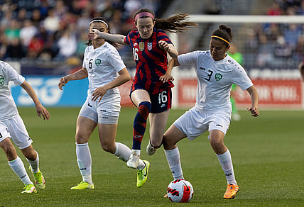 Apr 12, 2022; Chester, Pennsylvania, USA; United States midfielder Rose Lavelle (16) leaps over the defense of Uzbekistan defender Kuchkarova Ugiloy (3) during the first half of an international friendly women's soccer match at Subaru Park. Mandatory Credit: Bill Streicher-USA TODAY Sports