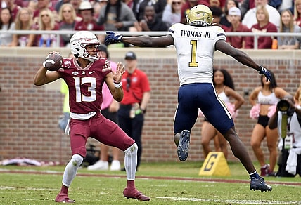 Oct 29, 2022; Tallahassee, Florida, USA; Florida State Seminoles quarterback Jordan Travis (13) is pressured by Georgia Tech Yellow Jackets linebacker Charlie Thomas (1)  during the first half at Doak S. Campbell Stadium. Mandatory Credit: Melina Myers-USA TODAY Sports