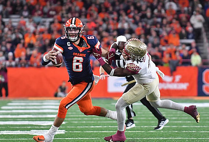 Nov 12, 2022; Syracuse, New York, USA;  Syracuse Orange quarterback Garrett Shrader (6) tries to shake a tackle by Florida State Seminoles linebacker Kalen DeLoach (4) in the second quarter at JMA Wireless Dome. Mandatory Credit: Mark Konezny-USA TODAY Sports