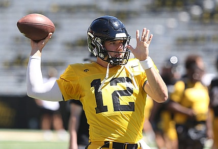 Iowa quarterback Cade McNamara (12) warms up before practice during Kids' Day at Kinnick Stadium on Saturday, Aug. 12, 2023, in Iowa City, Iowa