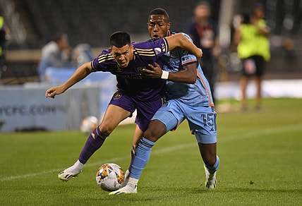 Sep 20, 2023; Queens, New York, USA; Orlando City SC midfielder Cesar Araujo (5) and New York City FC midfielder Andres Perea (15) battle for the ball during the first half at Citi Field. Mandatory Credit: John Jones-USA TODAY Sports