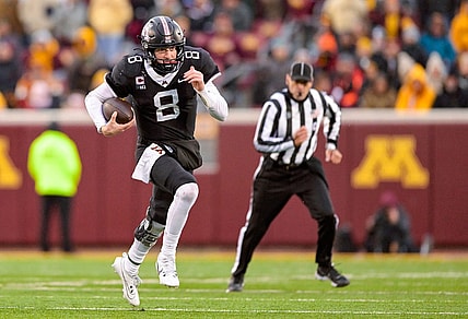 Oct 28, 2023; Minneapolis, Minnesota, USA;  Minnesota Golden Gophers quarter back Athan Kaliakmanis (8) runs for a first down against the Michigan State Spartans during the fourth quarter at Huntington Bank Stadium. Mandatory Credit: Nick Wosika-USA TODAY Sports