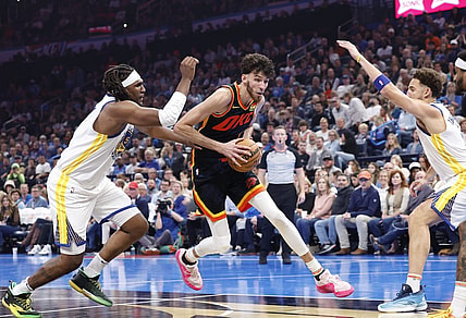 Nov 3, 2023; Oklahoma City, Oklahoma, USA; Oklahoma City Thunder forward Chet Holmgren (7) drives between Golden State Warriors forward Kevon Looney (5) and guard Klay Thompson (11) during the second quarter at Paycom Center. Mandatory Credit: Alonzo Adams-USA TODAY Sports