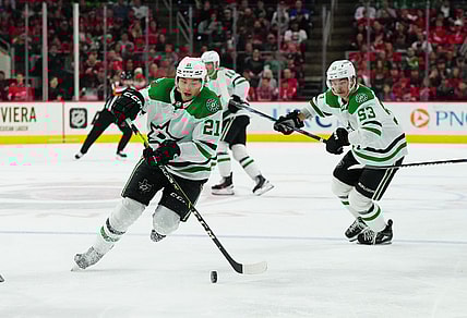 Feb 24, 2024; Raleigh, North Carolina, USA;  Dallas Stars left wing Jason Robertson (21) skates with the puck next to center Wyatt Johnston (53) during the second period against the Carolina Hurricanes at PNC Arena. Mandatory Credit: James Guillory-USA TODAY Sports