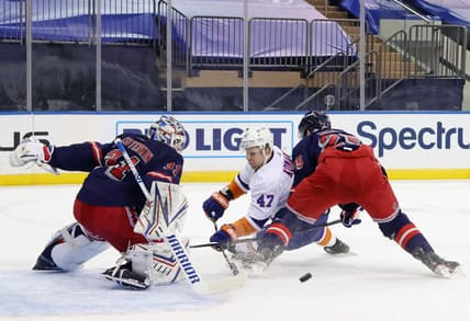 Feb 8, 2021; New York, NY, USA;  Igor Shesterkin #31 and Libor Hajek #25 of the New York Rangers combine to stop Leo Komarov #47 of the New York Islanders during the first period at Madison Square Garden on February 08, 2021 in New York City.  Mandatory Credit: Bruce Bennett/Pool Photo-USA TODAY Sports