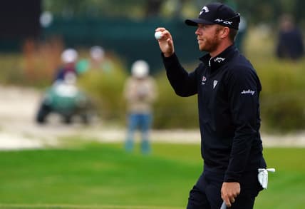 Nov 20, 2021; Sea Island, Georgia, USA; Talor Gooch waves to the gallery after his putt on the 18th green during the third round of the RSM Classic golf tournament at Sea Island Golf Club - Seaside Course. Mandatory Credit: John David Mercer-USA TODAY Sports
