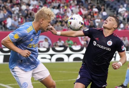 Jun 29, 2022; Chicago, Illinois, USA; Philadelphia Union defender Jakob Glesnes (5) heads the ball against Chicago Fire forward Chris Mueller (8) during the first half at Soldier Field. Mandatory Credit: Mike Dinovo-USA TODAY Sports