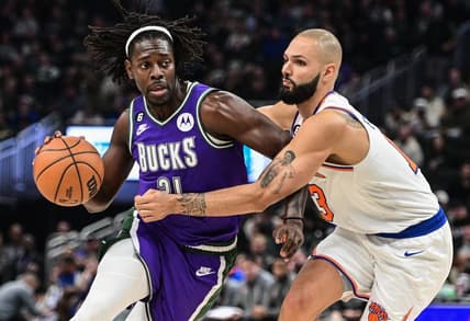 Oct 28, 2022; Milwaukee, Wisconsin, USA; Milwaukee Bucks guard Jrue Holiday (21) drives against New York Knicks guard Evan Fournier (13) in the second quarter at Fiserv Forum. Mandatory Credit: Benny Sieu-USA TODAY Sports