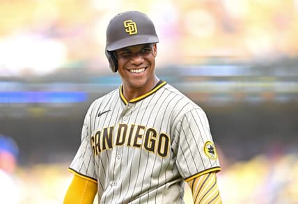 Sep 4, 2022; Los Angeles, California, USA;  San Diego Padres right fielder Juan Soto (22) smiles as he talks with players in the Los Angeles Dodgers dugout in the third inning at Dodger Stadium. Mandatory Credit: Jayne Kamin-Oncea-USA TODAY Sports