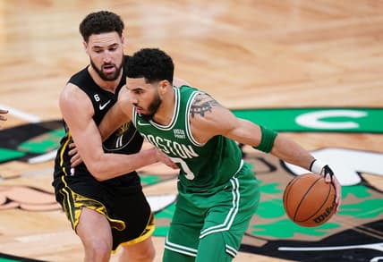 Jan 19, 2023; Boston, Massachusetts, USA; Boston Celtics forward Jayson Tatum (0) moves the ball against Golden State Warriors guard Klay Thompson (11) in the second quarter at TD Garden. Mandatory Credit: David Butler II-USA TODAY Sports